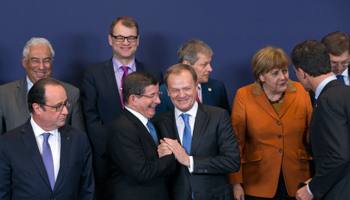 Prime Minister Ahmet Davutoglu, centred, poses with European Union leaders, during a EU-Turkey summit in Brussels (Reuters/Yves Herman)