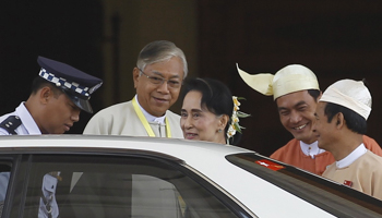 Myanmar's newly elected president Htin Kyaw and National League for Democracy party leader Aung San Suu Kyi leave the parliament at Naypyitaw, Myanmar (Reuters/Soe Zeya Tun)