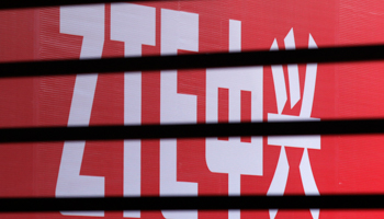 The company logo of ZTE is seen through a wooden fence (Reuters/Barry Huang)