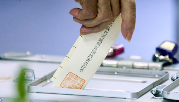 A woman casts her ballot on the members of the supreme court (Reuters/Thomas Peter)