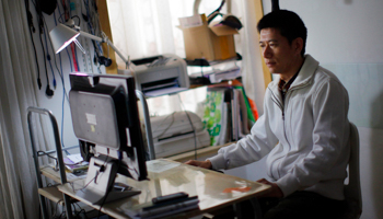 A PaiPaiDai lender works at his home office at a suburban area of Shanghai (Reuters/Carlos Barria)