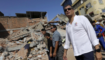 President Correa walks past a collapsed building after the recent earthquake, in Portoviejo, Ecuador (Reuters/Henry Romero)