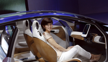 A woman sits inside the Nissan IDS concept car during the Auto China 2016 auto show in Beijing (Reuters/Kim Kyung)