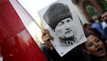 A demonstrator holds a poster of modern Turkey's founder Ataturk during a protest against Ismail Kahraman, Istanbul (Reuters/Murad Sezer)