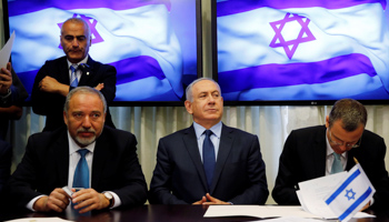 Avigdor Lieberman, left, and Benjamin Netanyahu sign coalition deal, May 2016 (Reuters/Ammar Awad)