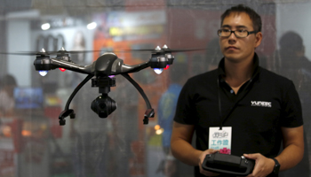 A man flies a drone at a computer show in Taipei (Reuters/Tyrone Siu)