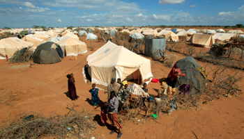 Refugees stand outside a tent at the Dadaab refugee site (Reuters/Thomas Mukoya)