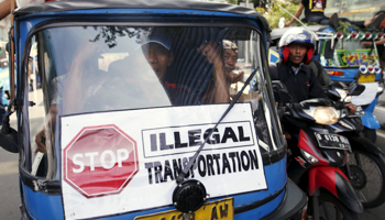 A traditional bajaj taxi takes part in a protest rally for ban on online taxi apps in Jakarta (Reuters/Darren Whiteside)