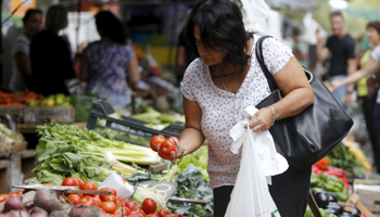 A woman buy vegetables in a street market in downtown Montevideo (Reuters/Andres Stapff)