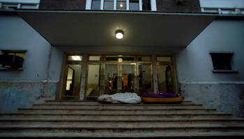 People sleep on mattresses at the door steps of a public hospital in Buenos Aires, Argentina (Reuters/Marcos Brindicci)