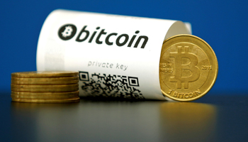 A bitcoin paper wallet with QR codes and a coin (Reuters/Benoit Tessier)