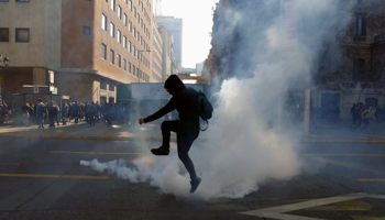 A demonstrator kicks a tear gas canister during a protest over the education (Reuters/Ivan Alvarado)