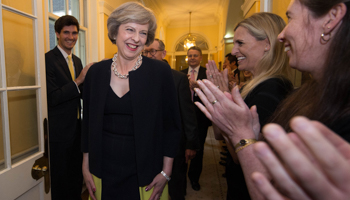 Staff applaud as Theresa May enters 10 Downing Street for the first time as UK prime minister (Reuters/Stefan Rousseau/Pool)