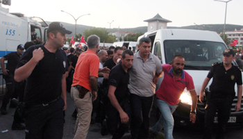 Admiral Namik Alper, commander of Aksaz naval base, arrives at a courthouse in Marmaris on July 17 escorted by plainclothes policemen (Reuters/Kenan Gurbuz)