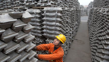 An employee checks aluminium ingots for export at the Qingdao Port, Shandong province, China (Reuters/Stringer/)