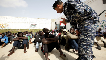 Libyan security officer talks to illegal migrant at Abu Saleem detention centre, Tripoli (Reuters/Ismail Zitouny)