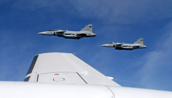 Saab JAS 39C Gripen fighter jets from F17 Wing of the Swedish Air Force demonstrate a mid-air interception over Sweden (Reuters/Tim Hepher)