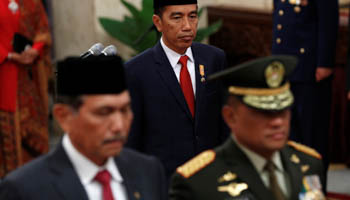 Indonesia's President Joko Widodo walks past the armed forces chief General Gatot Nurmantyo and former Coordinating Political, Legal and Security Affairs Minister Luhut Pandjaitan during the inauguration of the new national police chief at the presidential palace in Jakarta (Reuters/Darren Whiteside)