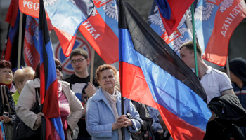 Donetsk residents carry Donetsk People's Republic flags at a rally celebrating the second anniversary of the self-proclaimed entity (Reuters/Alexander Ermochenko)