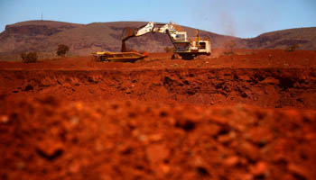 A giant excavator loads a mining truck at the Fortescue Solomon iron ore mine, Pilbara region of Western Australia (Reuters/David Gray)