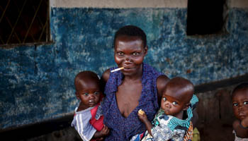 A woman holding her children in Bujumbura, Burundi  (Reuters/Goran Tomasevic)