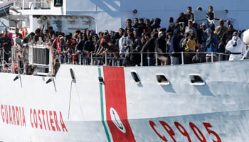 Migrants arrive by the Italian coastguard vessel Peluso in the Sicilian harbour of Augusta, Italy (Reuters/Antonio Parrinello)