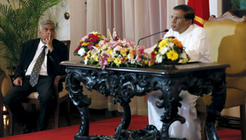 Prime Minister Ranil Wickremesinghe, left, looks on as President Maithripala Sirisena speaks to the media in Colombo (Reuters/Dinuka Liyanawatte)