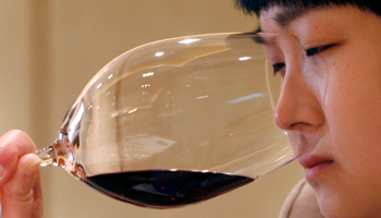 A woman smells red wine during a wine-tasting event in Beijing (Reuters/Claro Cortes IV)