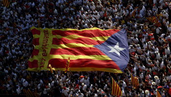Catalan pro-independence supporters hold a giant "estelada", Catalan separatist flag, during a demonstration in Barcelona (Reuters/Albert Gea)