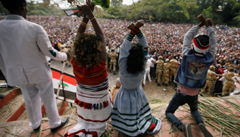 Demonstrators chant slogans and display Oromo protest gesture in Bishoftu town (Reuters/Tiksa Negeri)
