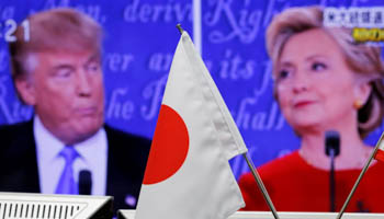 A Japanese flag is seen in front of a monitor displaying presidential election debate between Republican nominee Donald Trump and Democratic presidential nominee Hillary Clinton (Reuters/Toru Hanai)