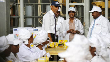 US President Barack Obama looks on as workers demonstrate part of the packaging process at a factory in Addis Ababa (Reuters/Jonathan Ernst)