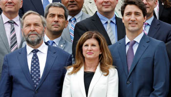 Canada's Prime Minister Justin Trudeau (R) stands next to Interim Conservative Leader Rona Ambrose (C) and New Democratic Party (NDP) leader Thomas Mulcair (L) (Reuters/Chris Wattie)