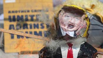 A pinata of U.S. Republican presidential nominee Donald Trump burns during a protest in Mexico City (Reuters/Edgard Garrido)