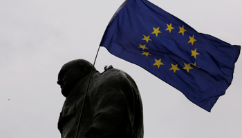 An EU flag waves over a statue of former UK Prime Minister Winston Churchill (Reuters/Luke MacGregor)