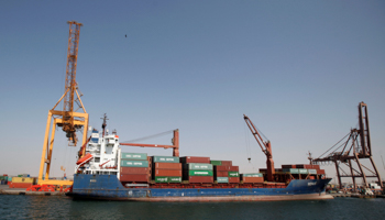 A ship unloads containers next to a crane, damaged by Saudi-led air strikes at the Red Sea port of Hodeidah (Reuters/Khaled Abdullah)