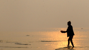 A Hindu pilgrim at the river Ganges and the Bay of Bengal (Reuters/Rupak De Chowdhuri)