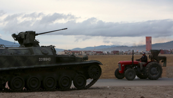 A resident drives his tractor past a military vehicle at a checkpoint on the perimeter of the Altiplano Federal Penitentiary, Mexico City (Reuters/Ginnette Riquelme)