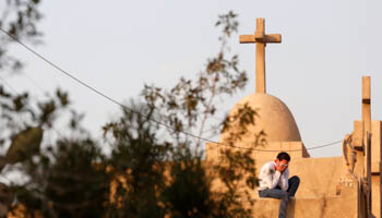 A mourner in the funeral of victims killed in the bombing of Cairo's Coptic cathedral (Reuters/Amr Abdallah Dalsh)