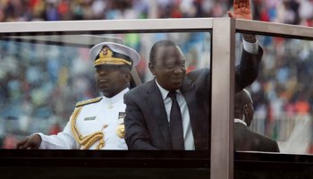 Kenya's President Uhuru Kenyatta waves from a bullet-proof enclosure on Jamhuri Day, Nairobi (Reuters/Thomas Mukoya)