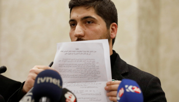 A spokesman for the Free Syrian Army rebel alliance holds up the ceasefire agreement with the Syrian government at a news conference in Ankara (Reuters/Umit Bektas)