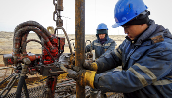 Oil well workers, southern Kazakhstan (Reuters/Shamil Zhumatov)