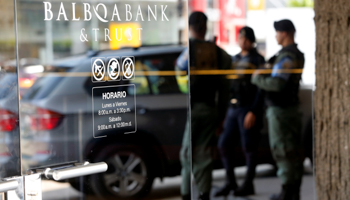 Police officers stand guard outside Balboa Bank and Trust in Panama City May (Reuters/Carlos Jasso)