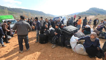 Syrians fleeing advancing pro-government Syrian forces wait for permission to enter Turkey in Latakia province (Reuters/Ammar Abdullah)