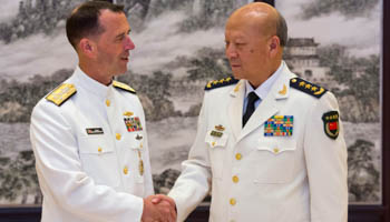Commander of the Chinese navy, Admiral Wu Shengli shakes hands with US Chief of Naval Operations Admiral John Richardson (Reuters/Ng Han Guan/Pool)