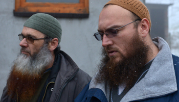 Two Bosnians speak to the media in the villiage of Gornja Maoca in February 2015, which has suspected links with radical Islamist groups (Reuters/Muhamed Kahrimanovic)