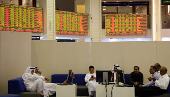 Traders monitor stock information at Dubai Financial Market, in Dubai, United Arab Emirates (Reuters/Stringer)