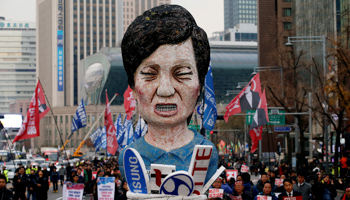 Trade unions members march with an effigy of President Park Geun-hye, calling for Park to step down (Reuters/Kim Hong)