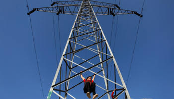 An Afghan boy plays on an electricity pylon in Kabul (Reuters/Mohammad Ismail)