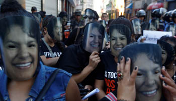 Demonstrators wear masks of slain environmental rights activist Berta Caceres during Honduran Women's Day, in Tegucigalpa, Honduras (Reuters/Jorge Cabrera)